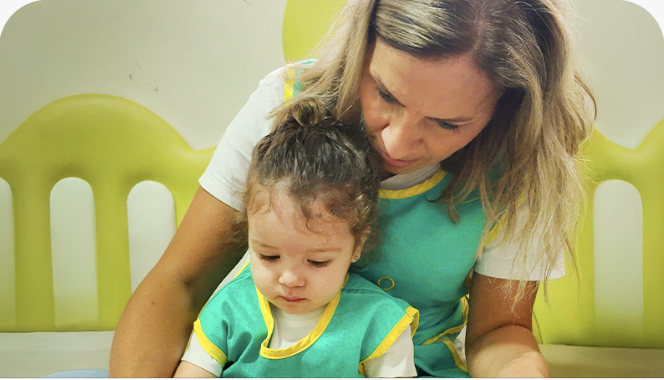 A caregiver and toddler at Poupon City